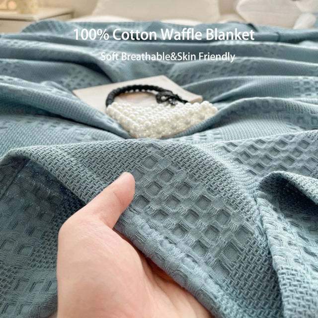 Waffle weave cotton throw blanket draped over a sofa